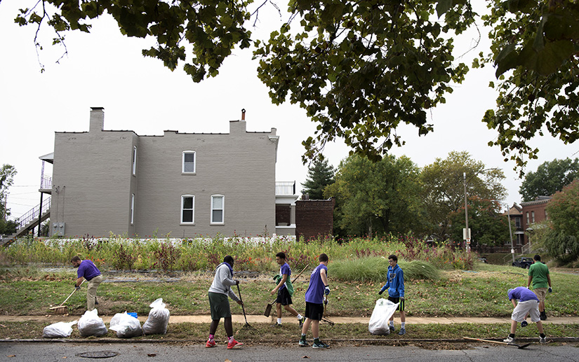 Students from St. Mary's High School cleaned the street and sidewalk near the intersection of Osceola Street and South Grand Avenue near the school in the Dutchtown neighborhood of St. Louis Monday, Oct. 9, 2017. The Dutchtown area around St. Mary's High School will be the focus of the new St. Joseph Housing Initiative to increase homeownership and add stability in neighborhoods.