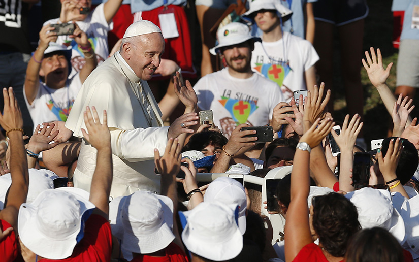 Pope Francis greeted the crowd at an evening meeting with Italian young adults at the Circus Maximus in Rome Aug. 11.