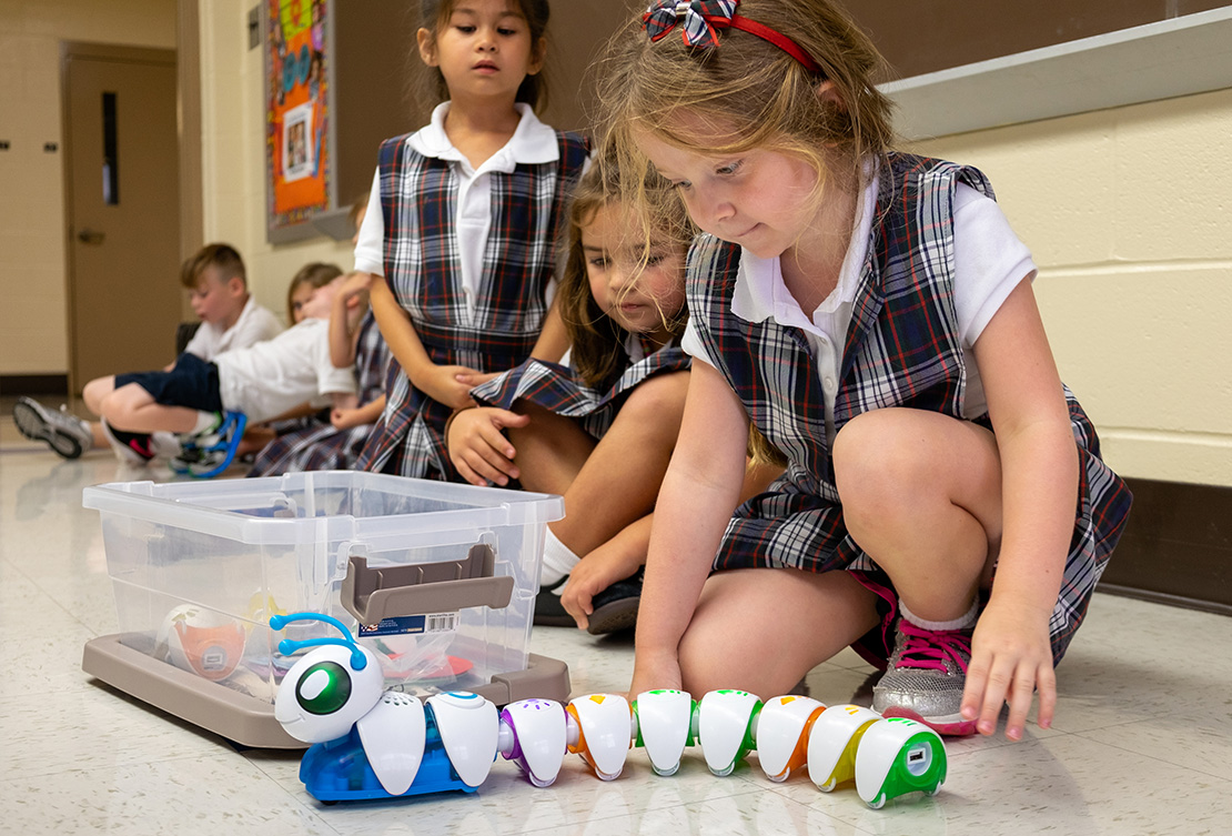 Hope Tavares, a kindergartner at Sts. Joachim And Ann School in St. Charles, joined other students working with a Fisher-Price Think and Learn Code-a-Pillar, a device used to teach basic coding skills, in the Innovation Station at the school Aug. 30. The is the focal point of the school’s STREAM teaching efforts.