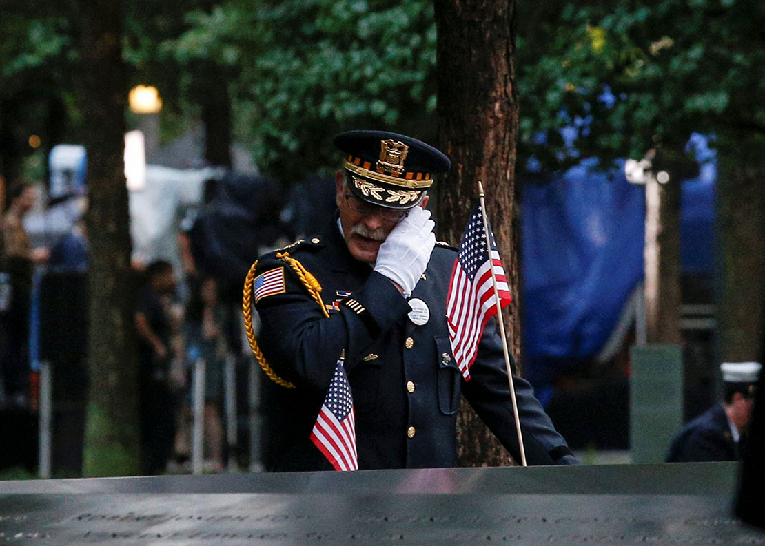An officer mourned at the National September 11 Memorial and Museum during ceremonies Sept. 11 marking the 17th anniversary of the attacks in New York. Nearly 3,000 people died in the attacks in New York City, Shanksville, Pa., and at the Pentagon.