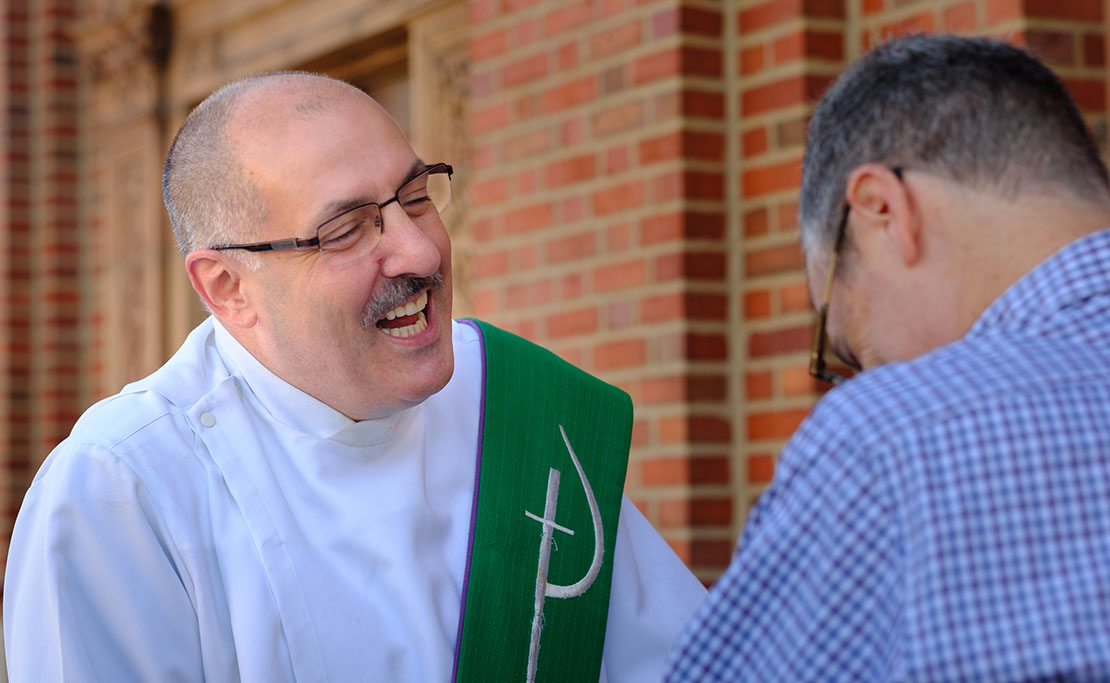 Deacon Joseph Fragale talked and laughed with parishioner Harold Ernst after Mass at St. Ambrose Church on The Hill on Sept. 23.