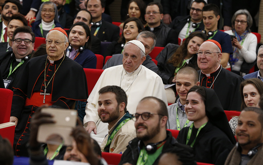 Pope Francis sat next to Cardinal Lorenzo Baldisseri, secretary-general of the Synod of Bishops, and Cardinal Kevin Farrell, head of the Vatican’s Dicastery for Laity, the Family and Life, for a group photo at a pre-synod gathering of youth delegates in Rome March 19. The Synod of Bishops on young people, the faith and vocational discernment will take place Oct. 3-28 at the Vatican.