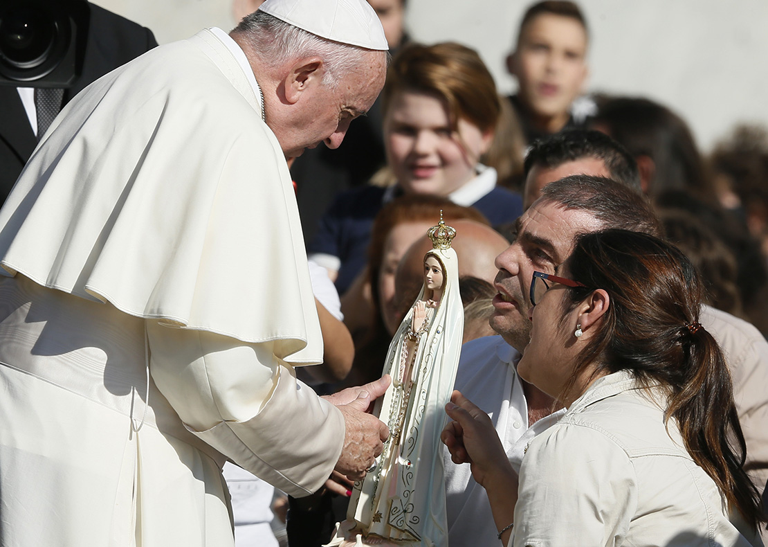 Pope Francis accepted a gift of a statue of Mary during his general audience in St. Peter’s Square at the Vatican Oct. 10.