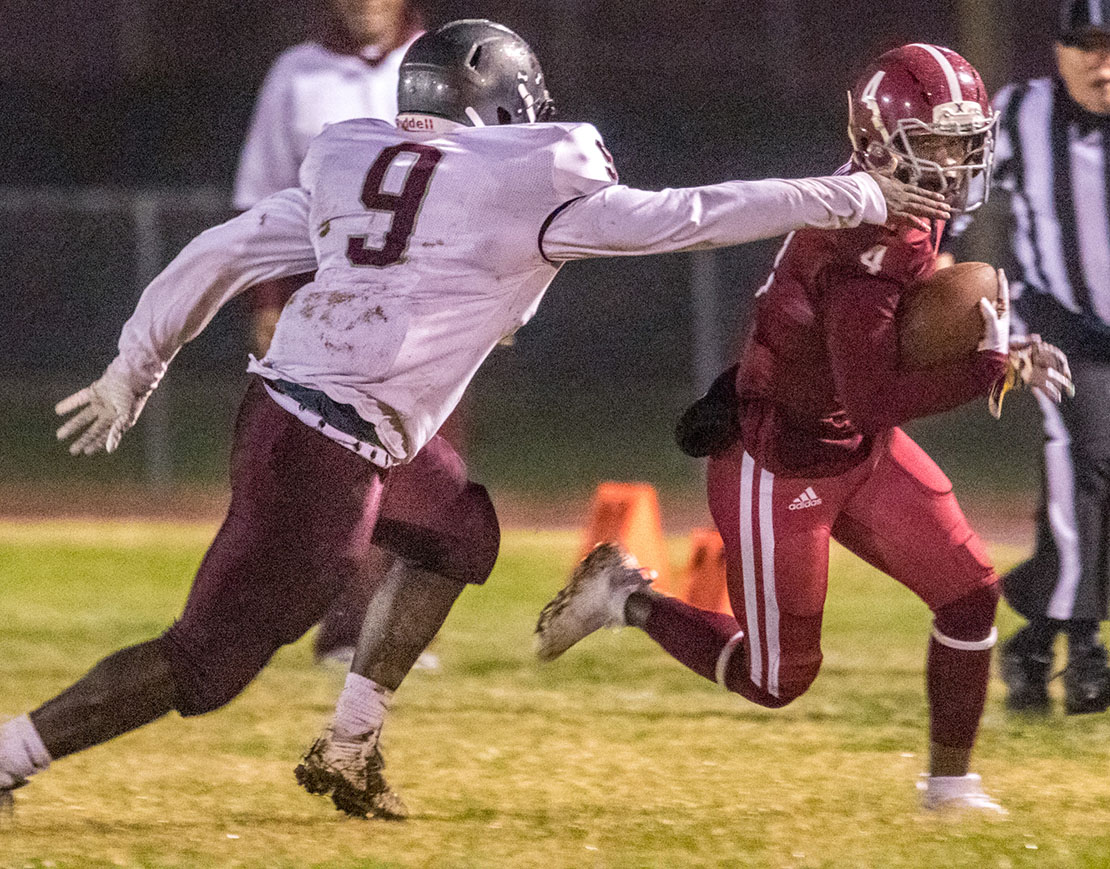 Trinity Catholic High School’s James Frenchie, right, ran for a gain before being tackled by Sumner’s Lorenzo Jenkins. Trinity opened district play Oct. 26 with their eighth straight win, defeating Sumner 88-0 on Senior Night at Trinity High School.