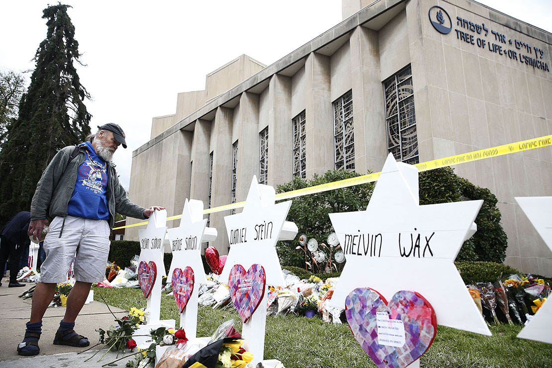 A man looked at the Star of David memorials Oct. 29 with the names of the people who were killed at the Tree of Life Synagogue in Pittsburgh. At least 11 people were killed and six others wounded, including four police officers, in a shooting Oct. 27 at the synagogue.