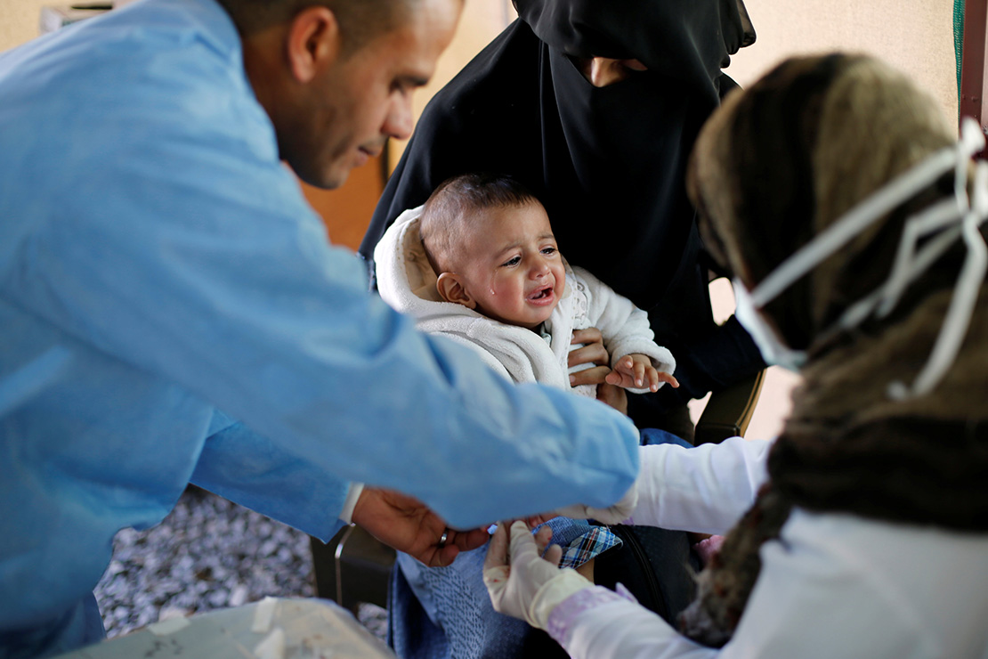 A doctor treated a child at a cholera treatment center Oct. 3 at a hospital in Sanaa, Yemen. Aid agencies and Catholic officials are sounding the alarm on Yemen’s spiraling humanitarian crisis, calling on the combatants to end the war and make badly need assistance available.