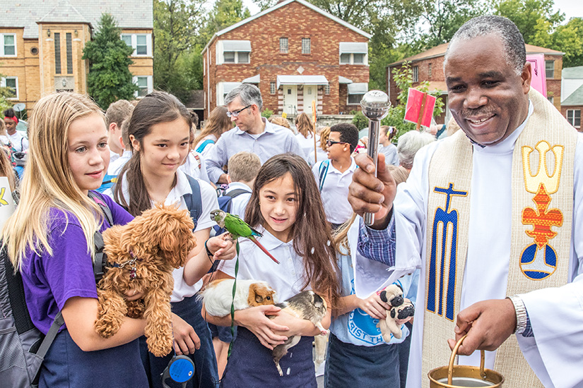Father Speratus Kamanzi blessed pets at Christ the King Parish in University City. Students brought their pets for the blessing on the Feast of St. Francis of Assisi.