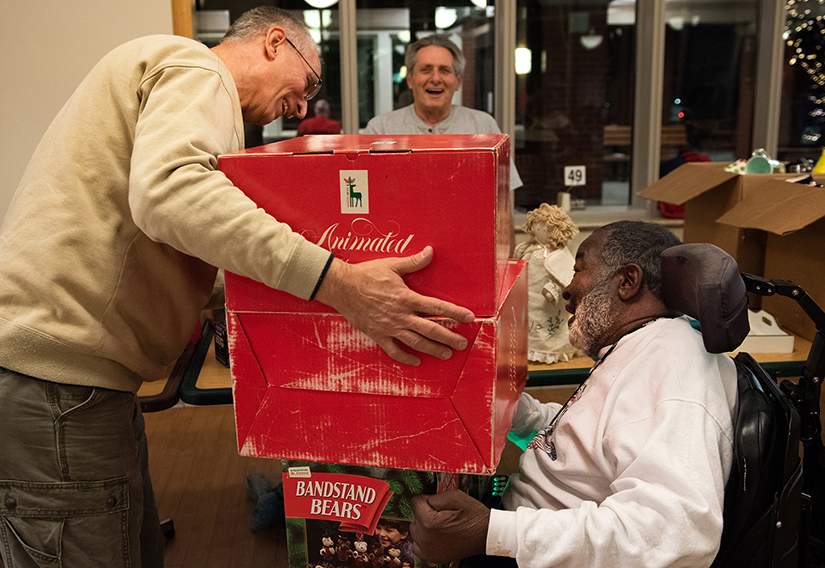 Rich Bauer, left, a veteran who organizes the annual St. Louis Tribute to the Troops Christmas party at the Missouri Veterans Home, presented gifts to resident Ernest Harris during the ninth annual party at the home in Bellefontaine Neighbors Dec. 18. Bauer organizes the event with fellow veteran Jeff Cluster.