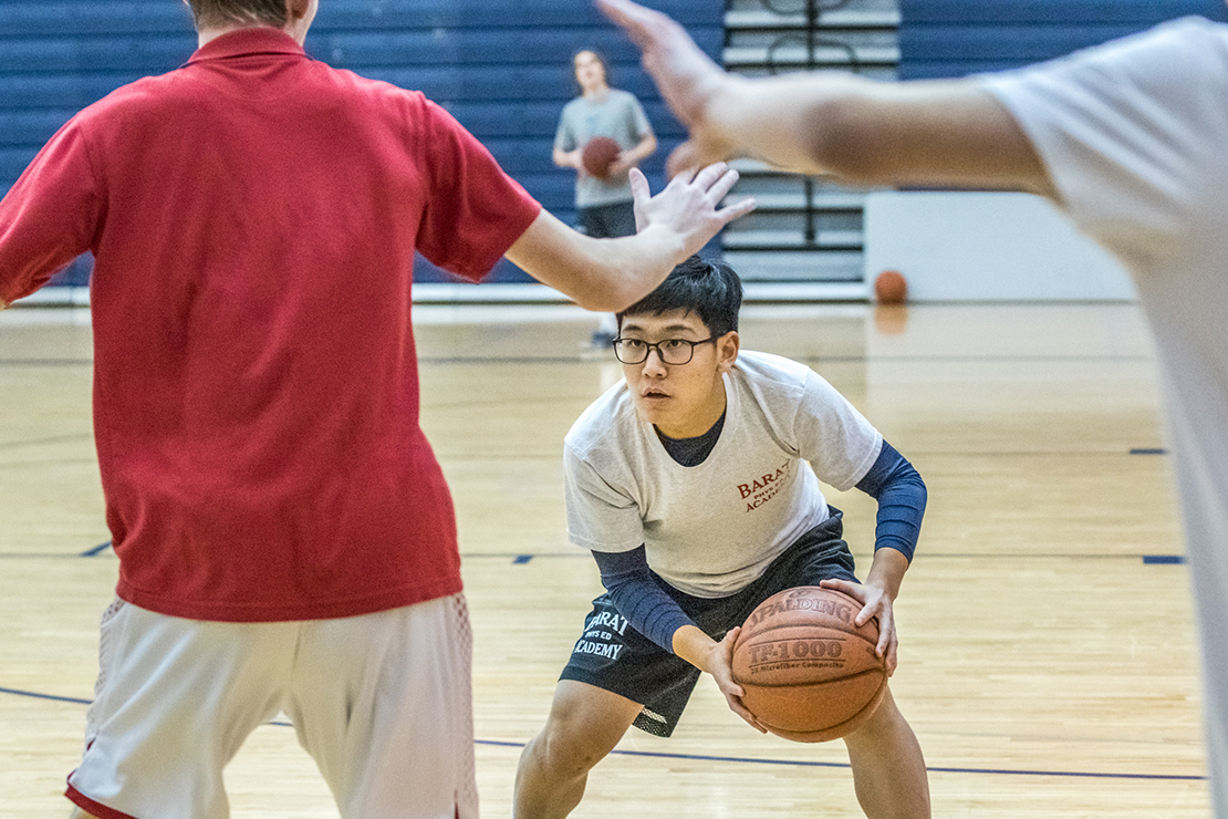 Tom Liu practiced with his Barat Academy teammates on Jan. 14. A sophomore from China, Liu came to Barat Academy at the beginning of the school year and is part of the blended basketball team made up of local and international players.