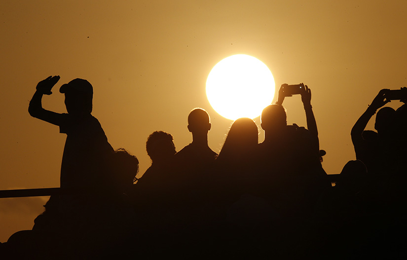Young people waiting for Pope Francis' arrival as the sun sets during World Youth Day before a prayer vigil at St. John Paul II Field in Panama City Jan. 26.