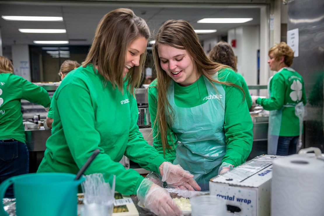 Kristen Fels and Casey Gerding wrapped a dinner plate at St. Patrick Center. Fels’ and Gerding’s grandparents, Butch and Sally Schulze, began volunteering and organizing fundraisers for St. Patrick Center, a tradition which is now carried on by younger members of their family.