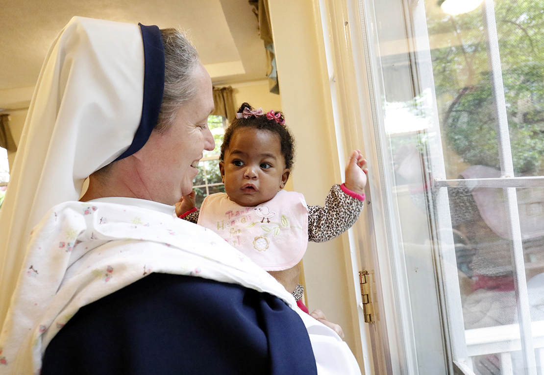 Sister Mary Elizabeth, vicar general of the Sisters of Life, held 6-month-old Esther at the religious community’s Holy Respite residence in the Hell’s Kitchen neighborhood of New York City in 2016. Holy Respite serves as a home and support center for pregnant women in crisis and new mothers.