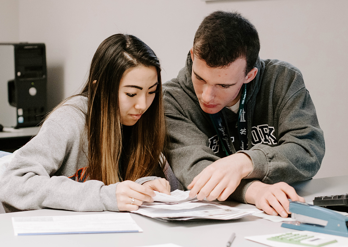 Rose Murphy and Paul Barber, students at Catholic Central High School in Troy, N.Y., examined a tax return March 3. The two are vounteers in the Catholic Charities Volunteer Income Tax program in the Diocese of Albany.