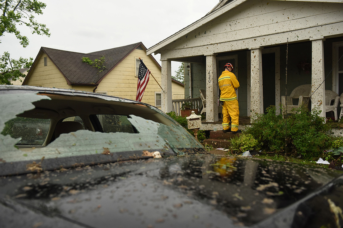 A firefighter checked houses May 23 following a tornado in Jefferson City, Mo. The May 22 tornado tore apart buildings in Missouri’s capital city as part of an overnight outbreak of severe weather across the state that left at least three people dead and dozens injured.