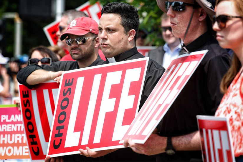 Kenrick-Glennon seminarian Robert Tull protested at Planned Parenthood in St. Louis on May 31, 2019.
