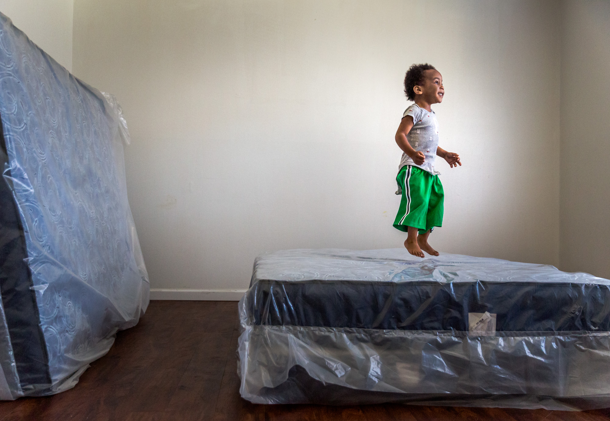 Ja’zon Reece, almost 3, bounced on top of the newly delivered matresses given to his mother, Annita Baker. Prior to the delivery of the three new mattresses from St. Vincent de Paul on March 14, Baker and her three sons had been sharing an air mattress since they moved into their one-bedroom apartment.