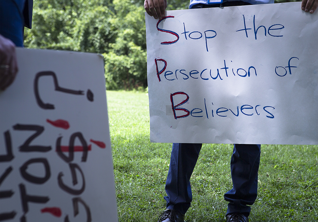 A participant held a sign at a Religious Freedom Rally in Washington July 10. It was one of several rallies held the same day in cities around the country and sponsored by Save the Persecuted Christians prior to the Ministerial to Advance Religious Freedom, which took place July 16-18 in Washington.