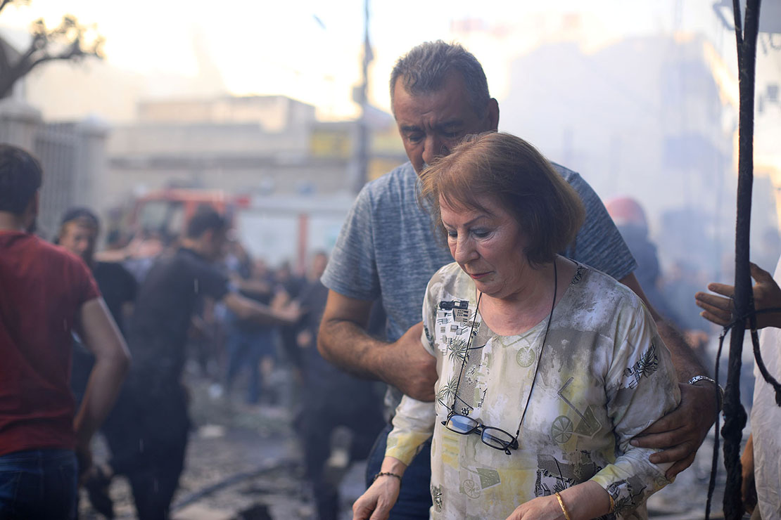 A woman left the site of a car bomb blast July 11 outside the Syriac Orthodox Church of the Blessed Virgin Mary in Qamishli, Syria, in the northeast part of the country near the border with Turkey. At least 11 people were injured in the blast during evening services. It was unclear who was responsible for the attack.