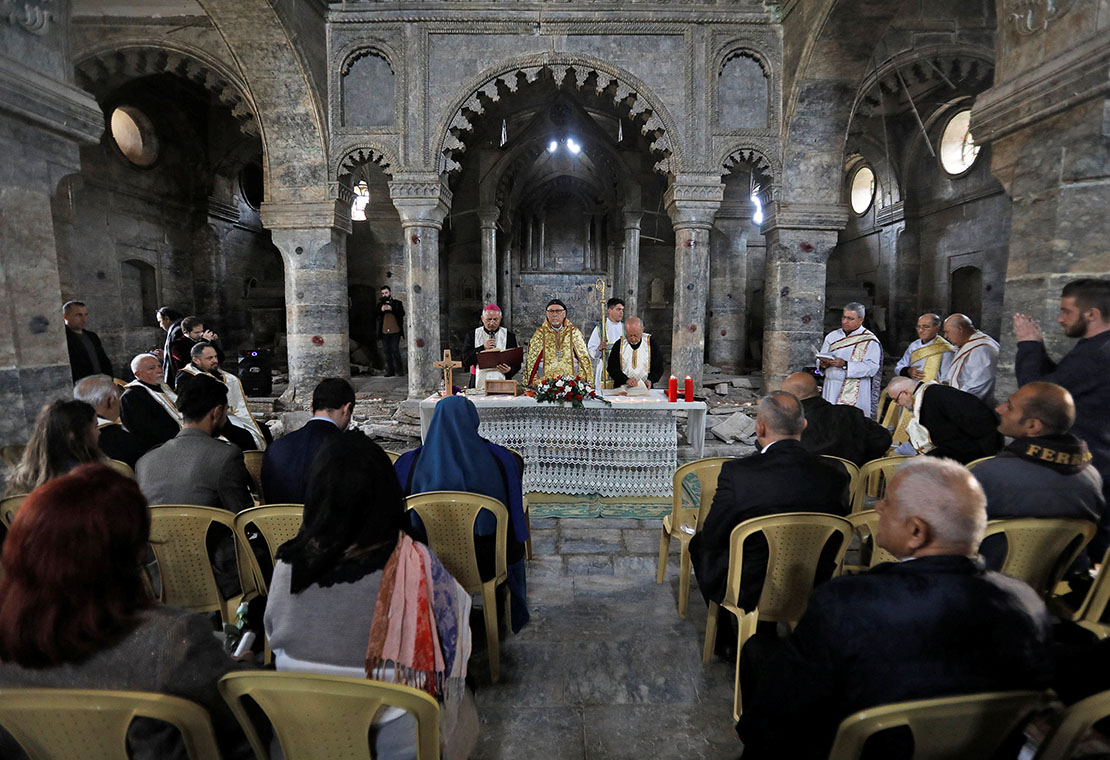 Syriac Catholic Archbishop Yohanna Moshe of Mosul, Iraq, center, concelebrated the liturgy at St. Thomas Syriac Catholic Church in the old city of Mosul Feb. 28, 2019.