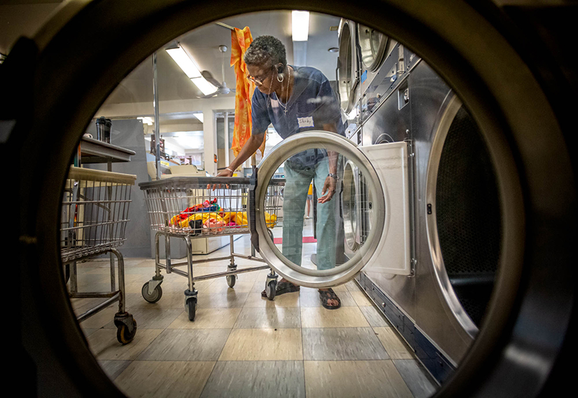 Shirley Lester, who is a member of Prince of Peace Baptist Church, loaded a dryer at Soulard Soap Laundromat & Cleaners Aug. 8. Lester lives in a senior housing apartment.