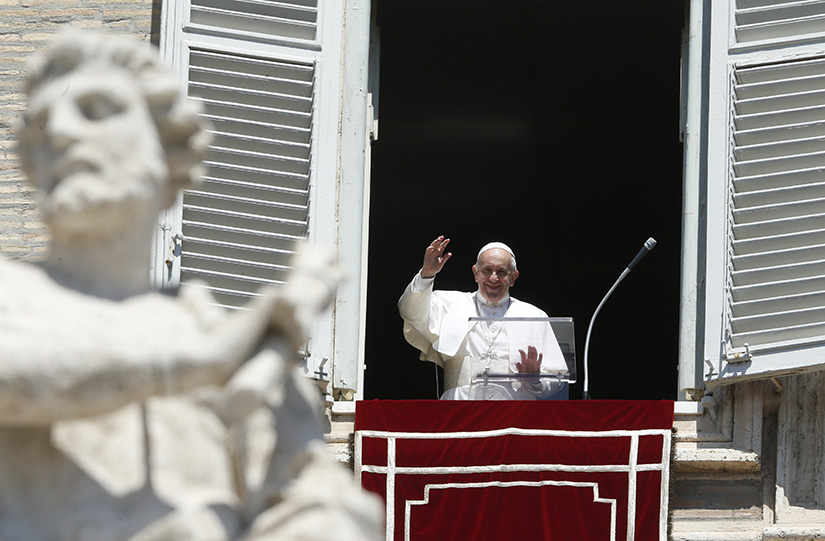 Pope Francis greeted the crowd as he led the Angelus from the window of his studio overlooking St. Peter’s Square at the Vatican Aug. 15, the feast of the Assumption.