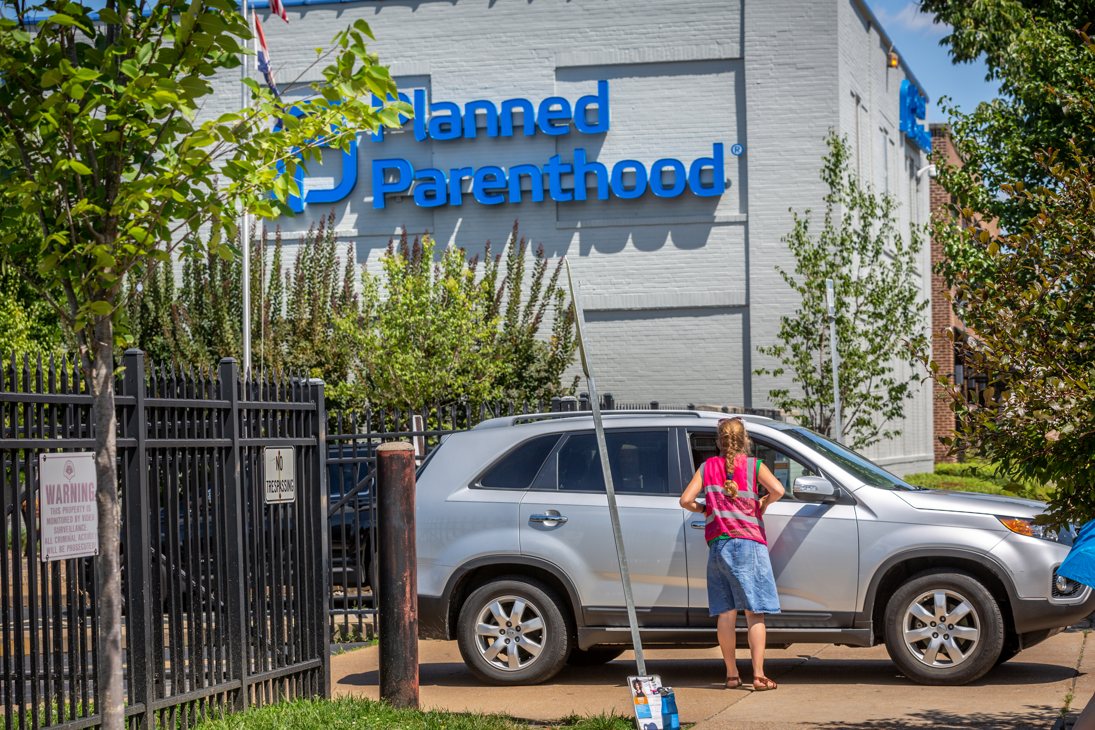 Coalition for Life volunteer sidewalk counselor Ellen Prize, a parishioner at St. Theodore in Flint Hill tried to talk to a visitor outside Planned Parenthood in St. Louis July 30.