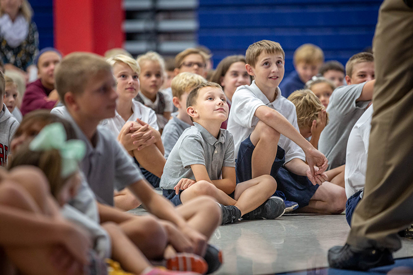 St. Theodore School in Wentzville first-grader William Mazes and seventh-grader Michael Belarde listened as Solomon Alexander encouraged students to care about sportsmanship and to be good to those around them – just as Stan Musial did during his illustrious career and life.