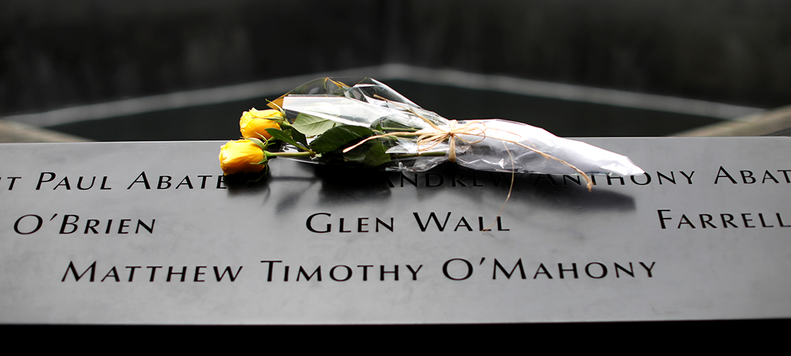 Flowers are seen left at the edge of the north reflecting pool at the 9/11 Memorial and Museum in New York City, Sept. 10, 2019, the eve of the 18th anniversary of the 9/11 terrorist attacks. 