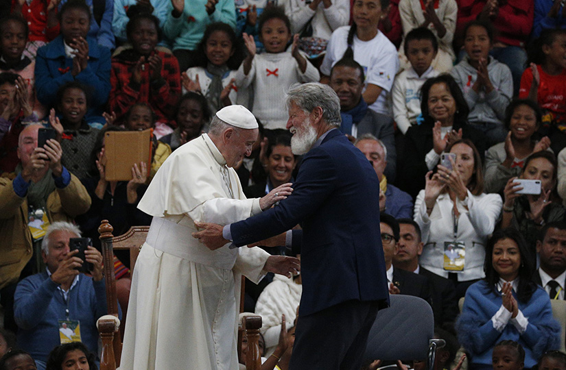 Pope Francis greeted Father Pedro Opeka, founder of the Akamasoa “Community of Good Friends,” during a meeting with members of the community in Antananarivo, Madagascar, Sept. 8. The pope said Father Opeka, who founded the community to combat poverty, was a student of his in the 1960s.
