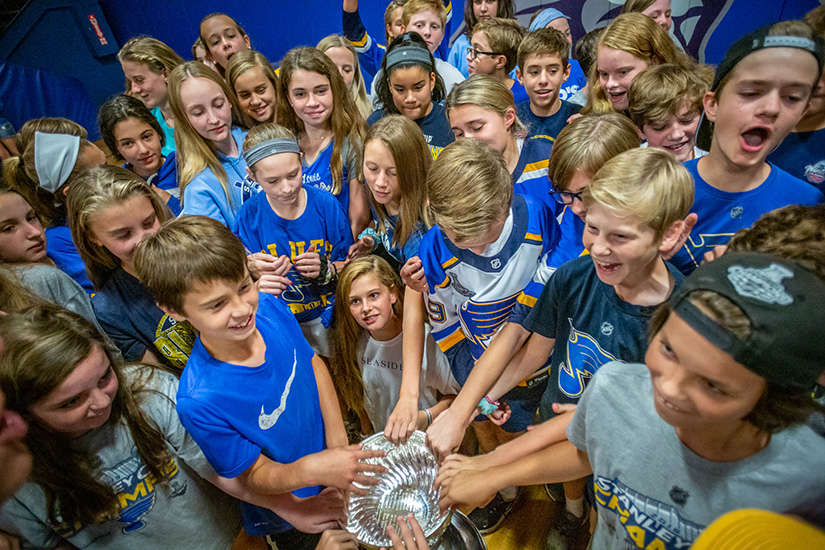 Seventh graders were able to touch the Stanley Cup, won by the St. Louis Blues in 2019, during a surprise visit to the students at St. Peter School in Kirkwood.