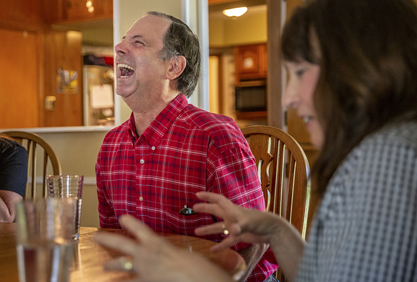 Edward Stoller, left, laughed with Susan Favazza at the kitchen table at L'Arche St. Louis' St. James house.