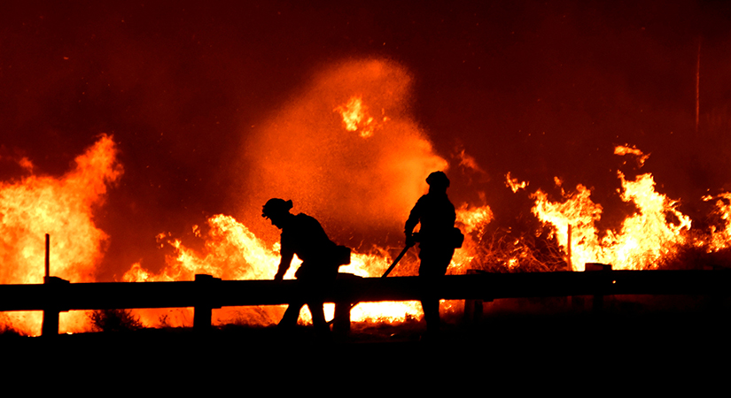 Firefighters battled a wind-driven wildfire Oct. 25 in Canyon Country near Los Angeles. The Archdiocese of Los Angeles is providing support to the communities affected by the fires through Catholic Charities of Los Angeles and local parishes and schools.