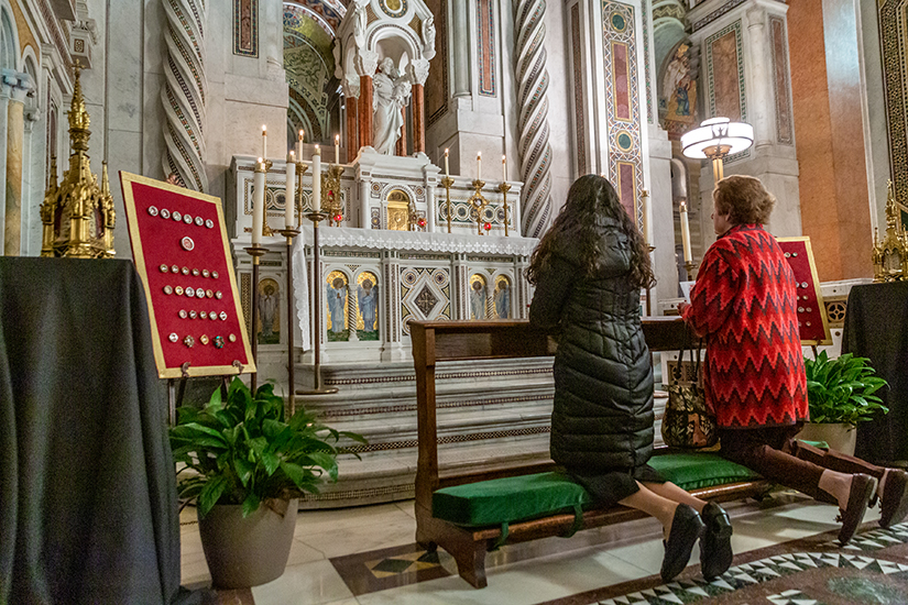 After Mass on All Saints day more than 140 relics were on display for veneration  at the Cathedral Basilica of Saint Louis in St. Louis, Missouri on Friday, Nov. 01, 201. Sister María Otilia Guerra Chinchilla, CCVI and Claire Vogt  prayed at the altar in the All Saints chapel.
