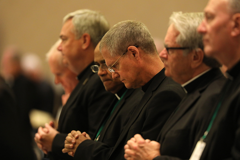 Archbishop Paul D. Etienne of Seattle, center, and other prelates prayed at the fall general assembly of the U.S. Conference of Catholic Bishops in Baltimore Nov. 12.