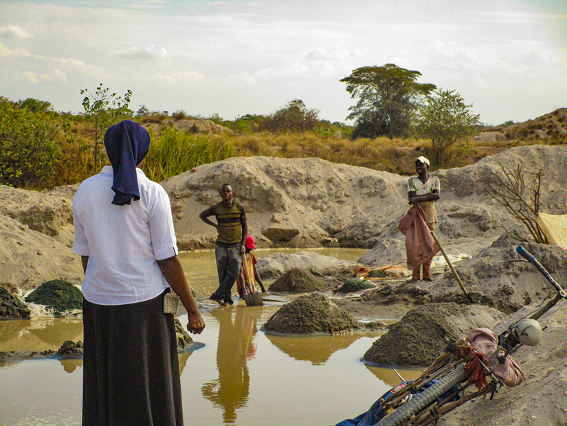Sister Catherine Mutindi observes workers at a cobalt mine in the Republic of Congo. She began an organization that addresses alternative livelihoods to mining and protecting children from working in the mines.