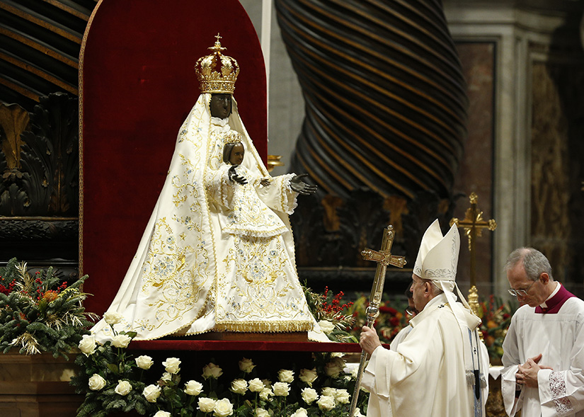 Pope Francis prayed in front of a statue known as Mary Mother of God, Crowned, at the conclusion of Mass on the feast of Mary Mother of God, in St. Peter’s Basilica at the Vatican Jan. 1. The Marian statue was brought to the Vatican from Foggia in southern Italy. According to legend, Mary appeared to a nobleman in the year 1001 and showed him the dark wooden statue.