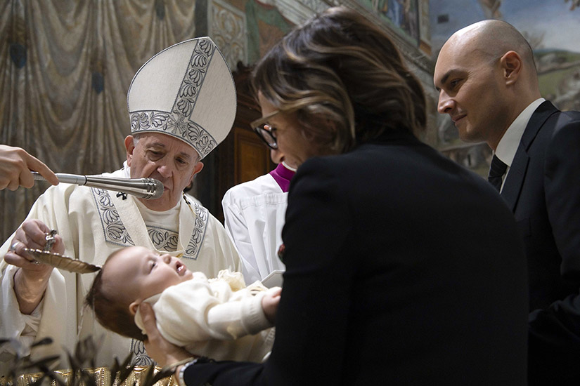Pope Francis baptized one of 32 babies as he celebrated Mass on the feast of the Baptism of the Lord in the Sistine Chapel at the Vatican Jan. 12.
