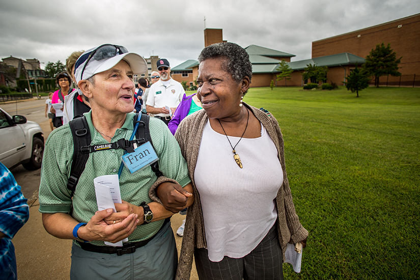 Francine Endicott Armstrong and Sharon Francis found they had more than the name "Francis" in common as they walked arm and arm along the "Crossing the Delmar Divide" pilgrimage.
A two-mile pilgrimage drawing attention to the history and reality of racism in St. Louis brought people of various ages, races and faiths together in an act of unity.
The "Crossing the Delmar Divide" pilgrimage Sept. 10 started at St. Louis University's clocktower where nearly 400 people walked through the streets of St. Louis. The pinnacle of the journey was a passage along Delmar Boulevard, a street that has become known as a visual example of the racial divide in St. Louis.
