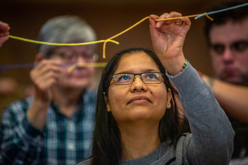 Sister Katty Huanuco, CCVI, held sections of string pieced together that represented working together against human trafficking at a prayer vigil and education session hosted by the U.S. Catholic Sisters Against Human Trafficking at Mercy Conference and Retreat Center in Frontenac Feb. 10.