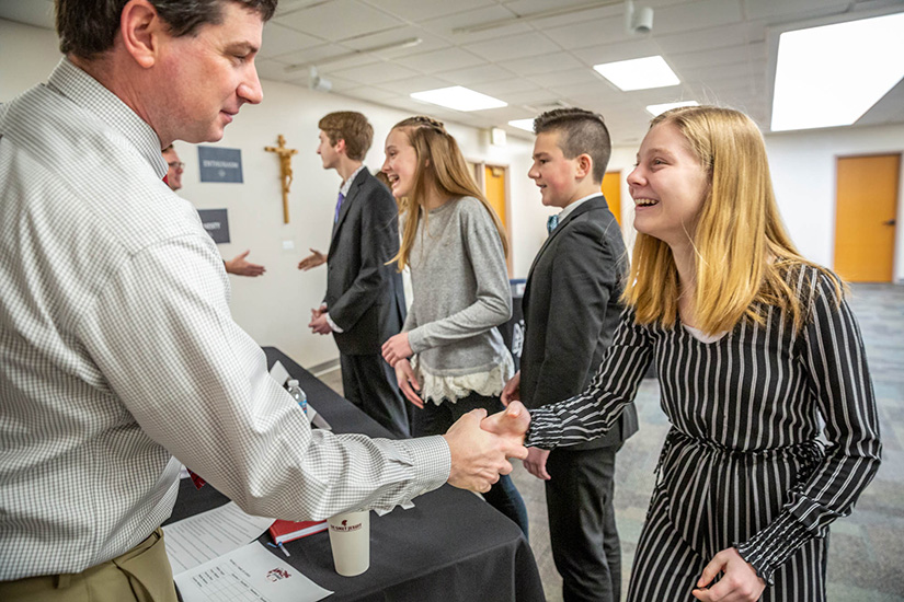 The final five contestants in the Amazing Shake competition were interviewed by four local high school principals and representatives at Incarnate Word School in Chesterfield Feb. 19. Molly Malone, who was named runner up, shook hands with De Smet Jesuit High School principal Kevin Poelker.