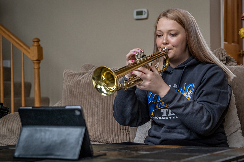 Isabella Nieder, a junior at St. Francis Borgia Regional High School, practiced her trumpet with her iPad at her home in Villa Ridge April 4. The Borgia band is using a variety of digital tools to keep practicing even though the school will engage in distance learning for the rest of the school year.