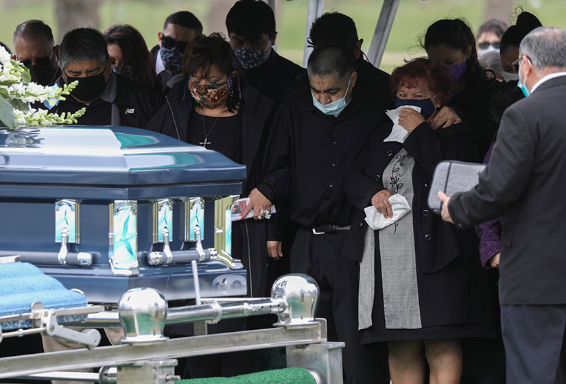 Family members attended the funeral of Saul Sanchez in Greeley, Colo., April 15 after he died of a COVID-19-related illness. The need for social distancing during the coronavirus pandemic is making the grieving process more difficult for those losing loved ones to the disease.