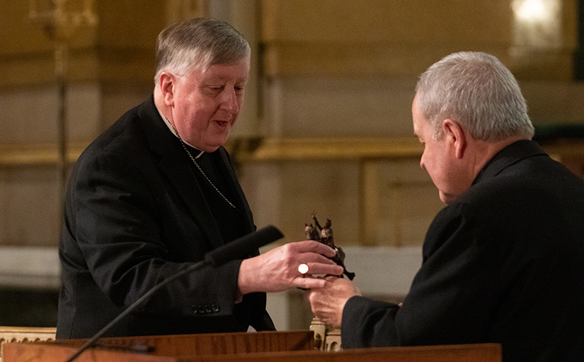 Archbishop Robert J. Carlson presented Archbishop-designate Mitchell Rozanski with a small replica of the Apotheosis of St. Louis -- the statue of King Louis IX -- at Cathedral Basilica of Saint Louis in St. Louis on June 10. Pope Francis accepted the retirement of Archbishop Carlson and appointed Bishop Rozanski of Springfield, Mass., as replacement.