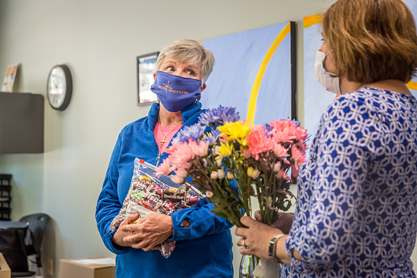 Business director Mary Kay Leary talked with Lisa Shea of Catholic Charities who delivered flowers, candy and handmade thank-you cards to the staff at Good Shepherd Children and Family Services June 11.