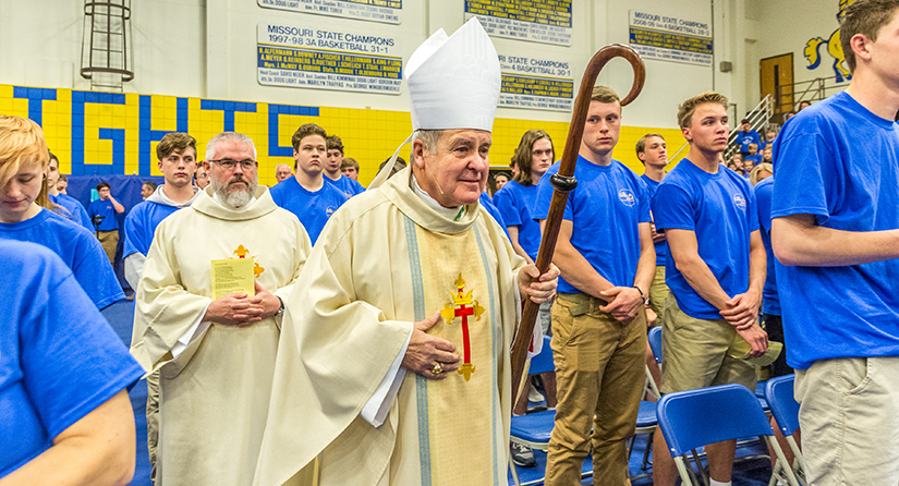 Archbishop Robert J. Carlson processed in for Mass at St. Francis Borgia Regional High School in Washington in 2018. The Mass was attended by the high school students as well as grade school students from local parish schools.