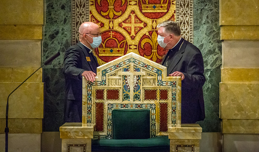 Archbishop-designate Mitchell T. Rozanski listened to Msgr. Henry Breier, rector of the Cathedral Basilica of Saint  Louis, explain how the cathedra was made from an old altar. Archbishop-designate Rozanski will be installed as the 10th archbishop of St. Louis on Aug. 25.
