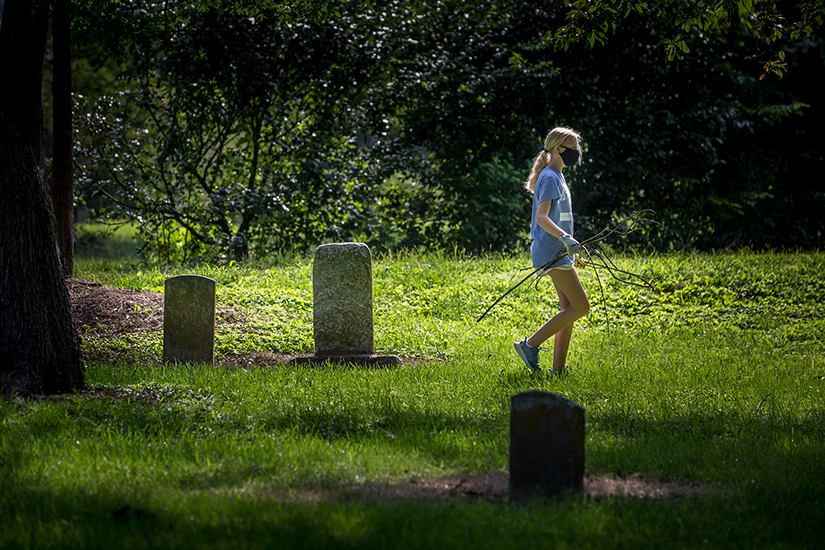 Ursuline Academy freshman Cate Rathouz cleared tree branches at the Father Dickson Cemetery in Crestwood on Aug, 14. Freshmen spent part of the day doing service at the cemetery as part of the school’s ‘Viaggio Days’ orientation.