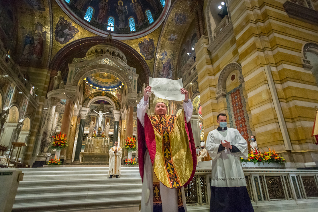 Archbishop Mitchell T. Rozanski displayed to the congregation the mandate appointing him as Archbishop of St. Louis. Archbishop Rozanski was installed Aug. 25, the feast of St. Louis.