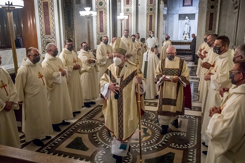 Archbishop Mitchell Rozanski walked into the side chapel of the Cathedral Basilica of Saint Louis to give the newly ordained deacons their assignments for the Archdiocese of St. Louis. Archbishop Rozanski ordained 22 men as permanent deacons Aug. 29.