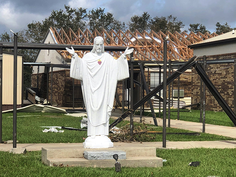 A statue of the Sacred Heart of Jesus is seen outside of St. Pius X Church in Ragley, La., Sept. 1, 2020, with signs of damage from Hurricane Laura.